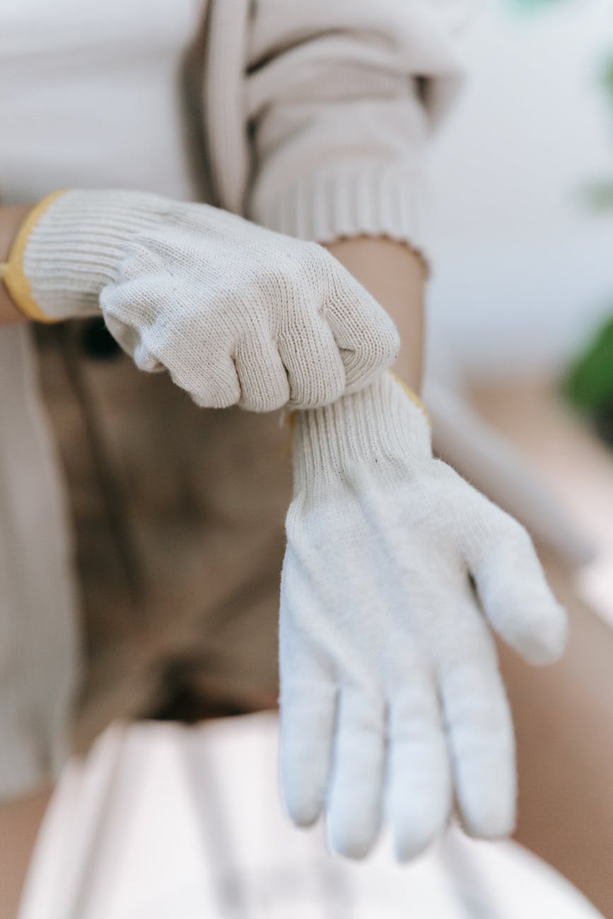 person wearing white garden gloves